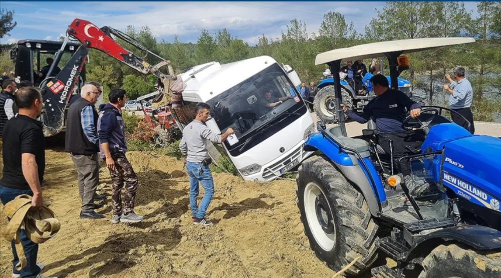 Yoldan çıkan ve devrilmemesi için traktörlere bağlanan  midibüsteki 23 kişi kurtarıldı